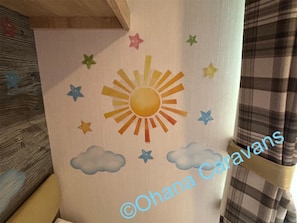 A wall with a painted sun and clouds, and stars. - Silver 3 Bedroom Caravan Located at Seton Sands H (Prestonpans)