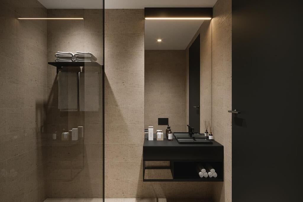 A modern bathroom with a glass shower enclosure, a black vanity with a mirror, and a recessed ceiling light.