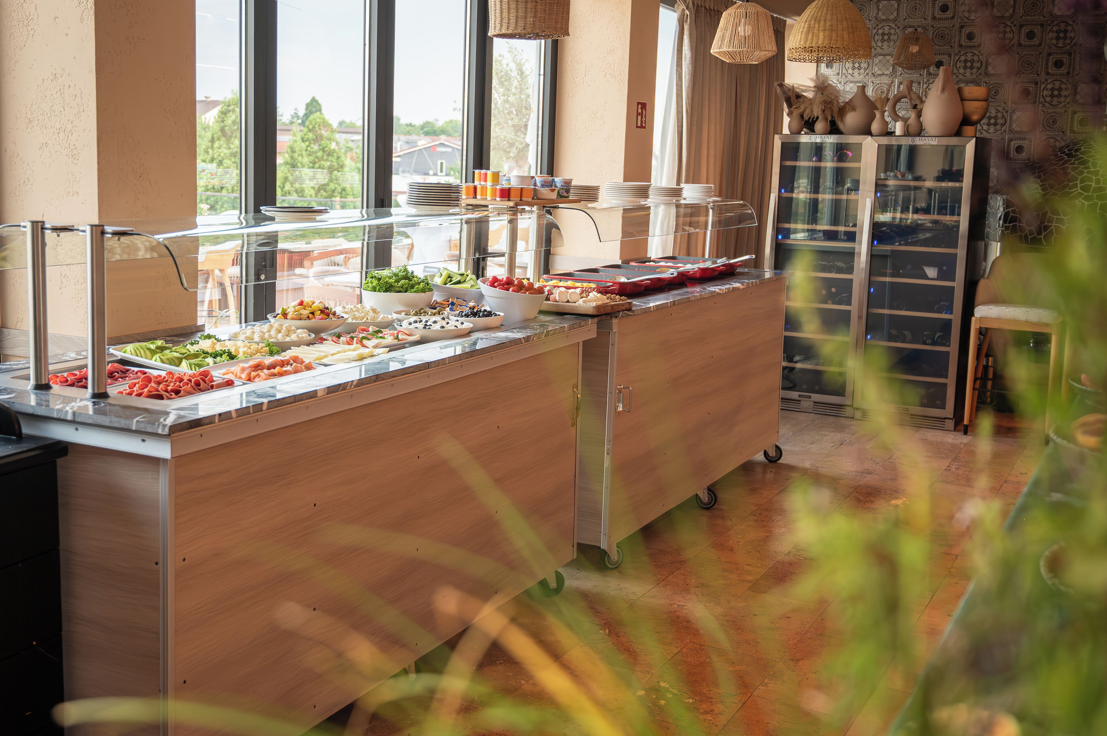 A buffet setup with various food items and a glass display case.