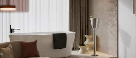 A modern bathroom with a freestanding bathtub, a floor lamp, and a sofa.