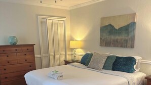 A neatly arranged bedroom with a bed, dresser, and a ceiling fan. - FIFA 2026 Walk to Stadium | 2BR Unit 10G ATL (Atlanta)