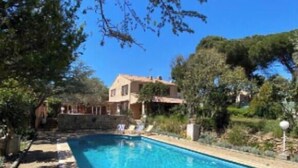 A rectangular swimming pool with a tiled edge, surrounded by a stone deck. - Authentic Provencal Villa with Pool For a Perfect Family Retreat (La Ciotat)