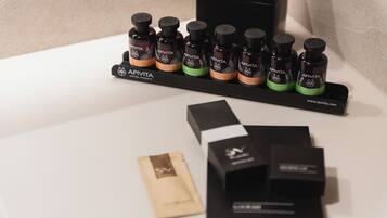 A display of Apivita natural products, including various bottles and boxes on a table.