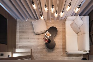 Family Suite with Loft and Mountain View | Living area | 32-inch TV with digital channels - Revi Mountain Resort Boutique Hotel (Kalavrita)