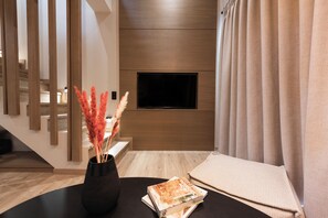 Family Suite with Loft and Mountain View | Living area | 32-inch TV with digital channels - Revi Mountain Resort Boutique Hotel (Kalavrita)