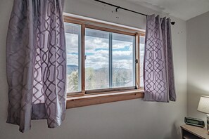 Enjoy a peaceful view from the window, featuring a distant landscape.