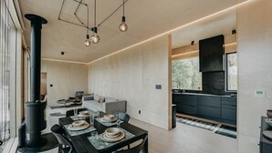 A modern kitchen with dark cabinetry, a built-in stove, and pendant lighting. - 58mf - Wi-fi - Pets Ok - Evc - Amazing Views 2 Bedroom Cabin by RedAwning (Maple Falls)