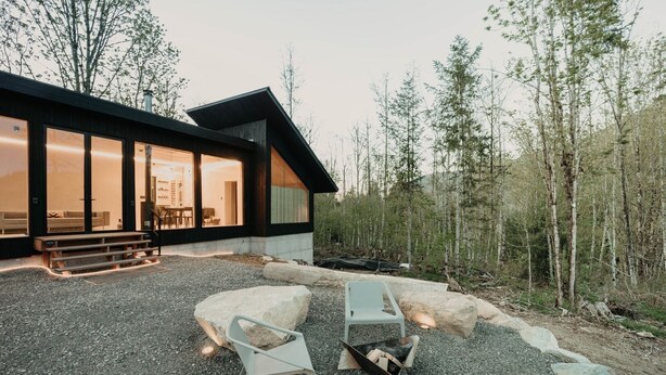 A modern cabin with large windows, a stone fireplace, and outdoor seating. - 58mf - Wi-fi - Pets Ok - Evc - Amazing Views 2 Bedroom Cabin by RedAwning (Maple Falls)