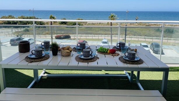 A table set with various items on a balcony overlooking the sea. - Dunas Beach with sea views in Torrox Costa (Torrox Costa)