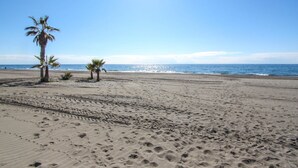 A sandy beach with footprints and palm trees. - Dunas Beach with sea views in Torrox Costa (Torrox Costa)