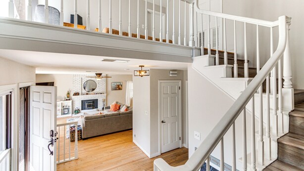 A spacious living area with a staircase, a kitchen, and a cozy seating area. - Beautiful Kernville Home w/ Game Room & Mtn Views! (Kernville)