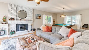 A living room with a fireplace, a pool table, and a sofa. - Beautiful Kernville Home w/ Game Room & Mtn Views! (Kernville)