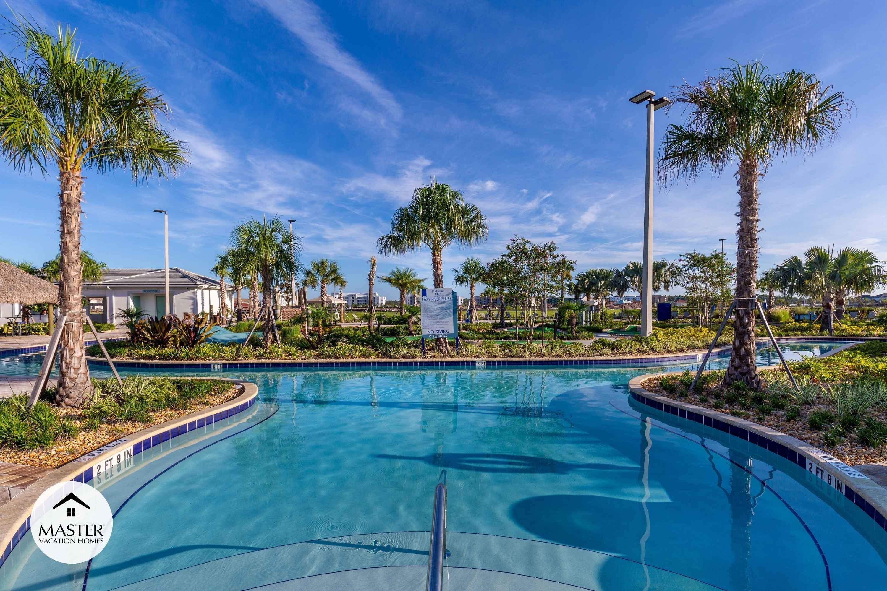 A clear blue swimming pool with a 2 ft 9 in depth, surrounded by palm trees and a sign that reads "NO DIVING".