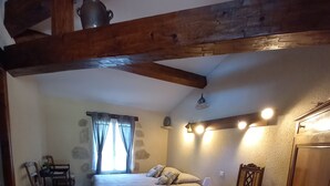 A bedroom with a bed, a chair, a desk, and a wardrobe. - Mas Laborde (Mauroux)