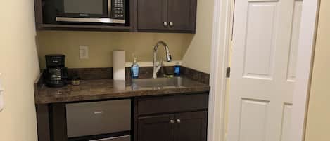 Fridge, microwave, coffee/tea maker, cookware/dishes/utensils