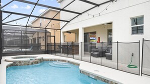 A pool area with a hot tub, outdoor seating, and a covered patio. - Last Minute Disney! Private Pool, Hot Tub, Game Room & Themed Bedrooms. Book Now! #112541 (Orlando)