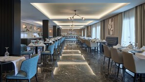 A spacious dining area with a long table, multiple chairs, and a central bar.