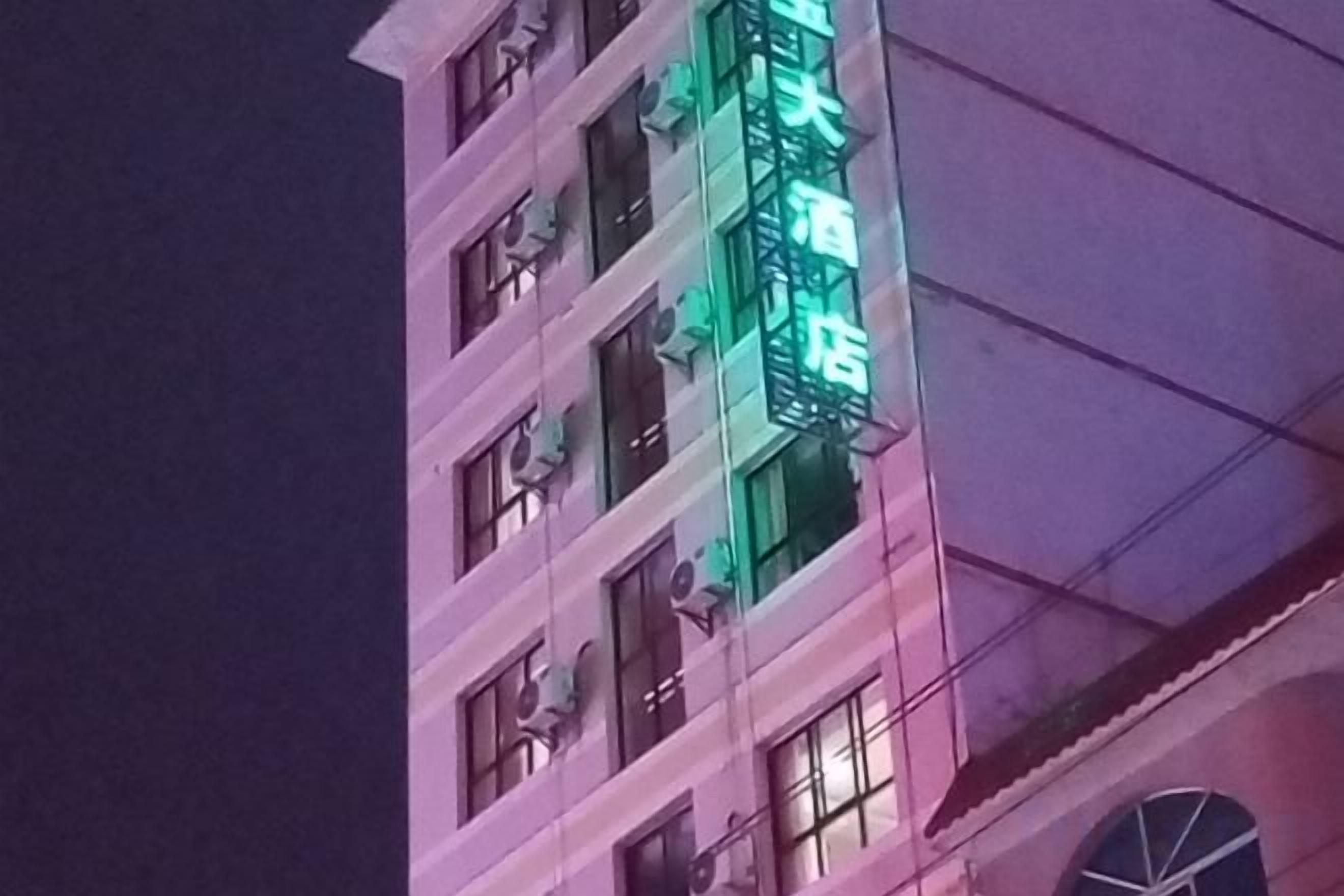 A multi-story building with a prominent sign.