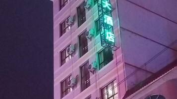 A multi-story building with a prominent sign.