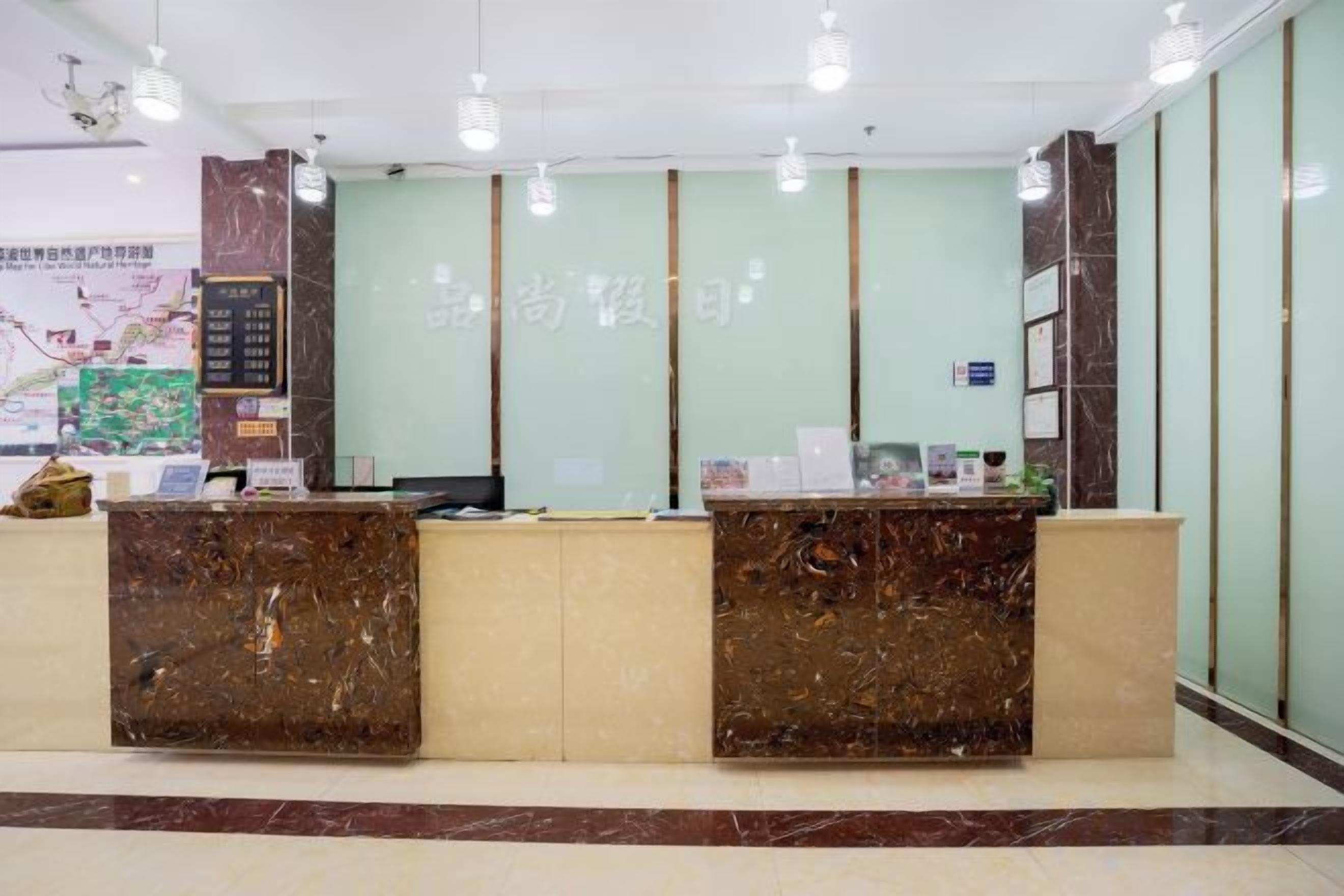 A reception area with marble reception desks, a map on the wall, and a light-colored floor.