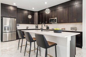 Fridge, microwave, oven, stovetop - The Stylish | NEW Home w Designer Decor, PVT Pool & Theme BR - Mins to Universal (Orlando)