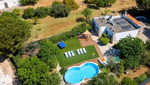 An aerial view of a property with a swimming pool, a covered patio with lounge chairs, and a solar panel array. - Villa Ambra by Villa Plus (San Vito dei Normanni)