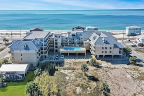 A beachfront hotel with multiple buildings, a swimming pool, and a view of the ocean. - Modern Beach Condo, Pool, Hot tub (Mexico Beach)