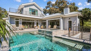A modern house with a large swimming pool, a covered patio, and a two-story structure. - Spacious Home w/ Pool & Short Trip to the Beach (Hilton Head Island)