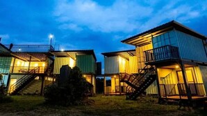 A row of modular cabins with external staircases and balconies, set against a twilight sky. - The Reef Diving Resort 海景雙人房b (Taitung County)