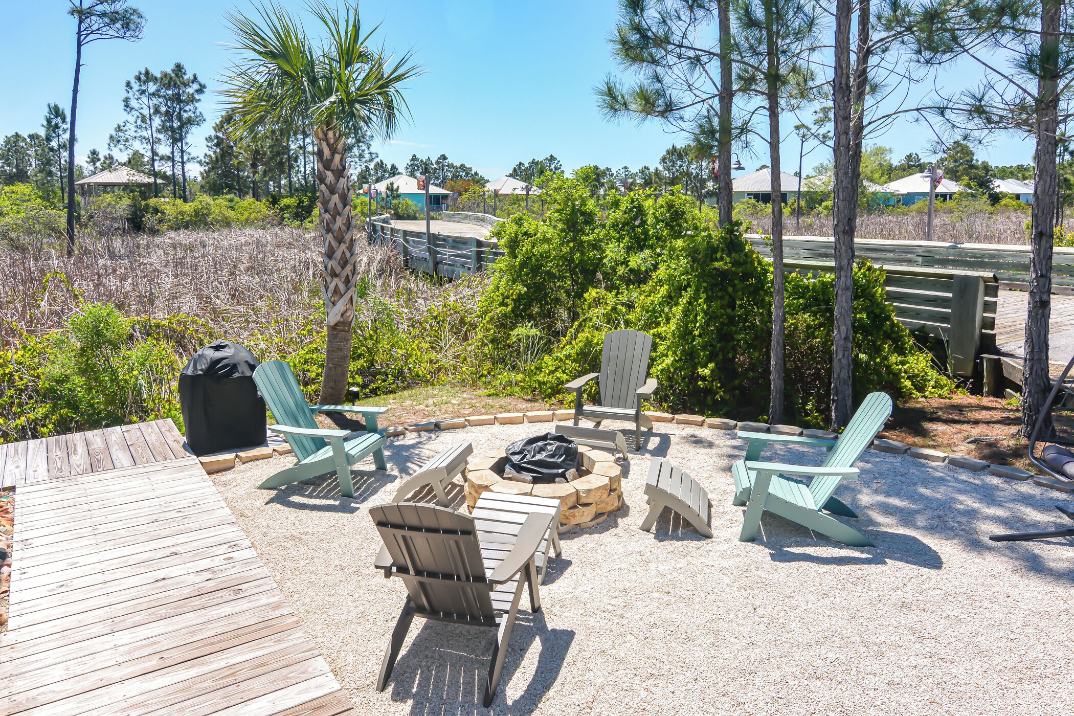 A deck with outdoor seating and a fire pit.