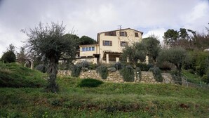 A two-story stone house with a stone wall and a metal fence in front. - Nice rustico with see view (Canal D'oro)