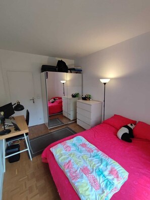 A bedroom with a bed, desk, wardrobe, and bedside lamps. - Bright Apartment With Garden Near Paris & Bois de Vincennes, all Commodities (Maisons-Alfort)