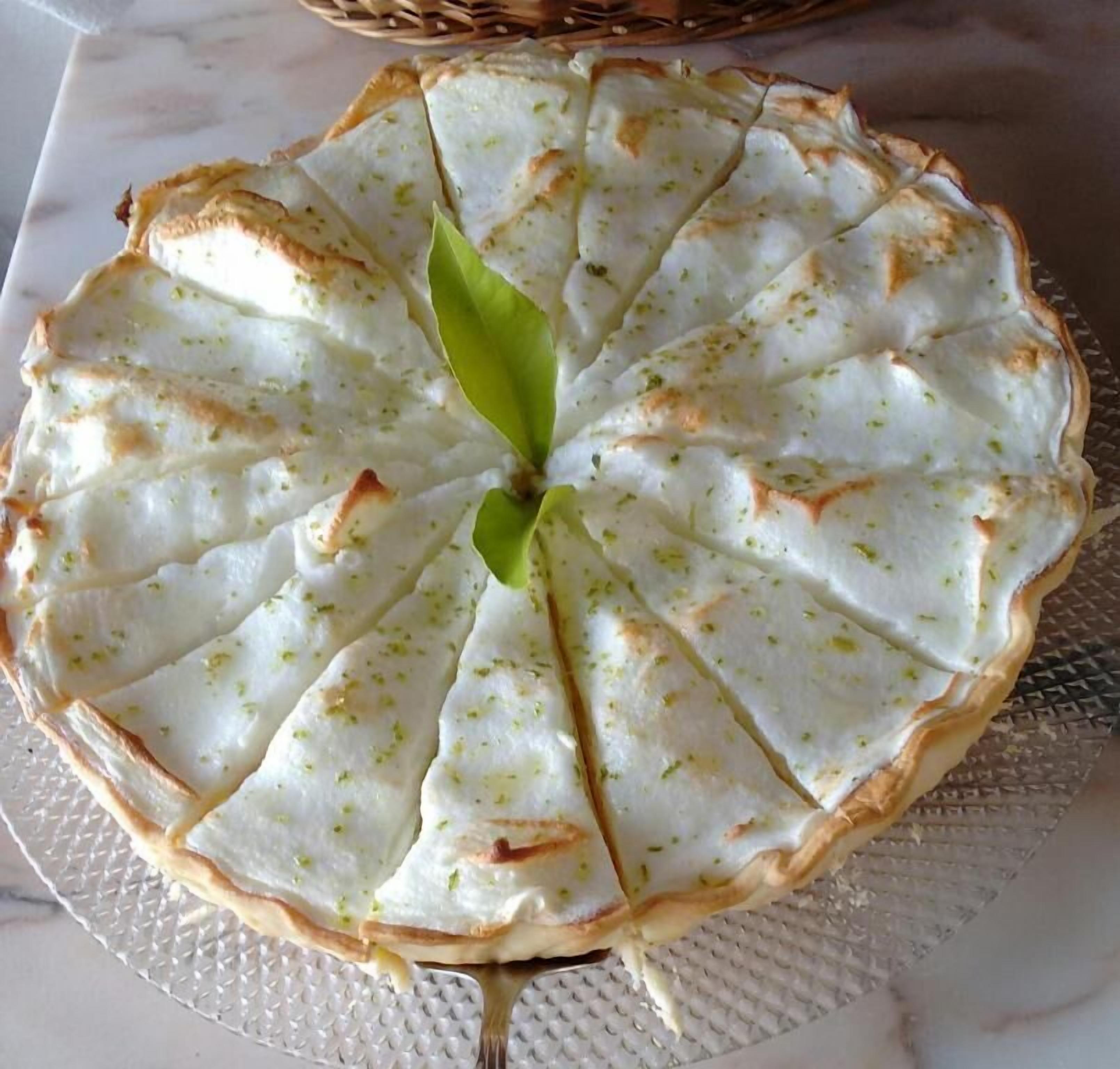 A round pie with a lattice crust on a white plate.