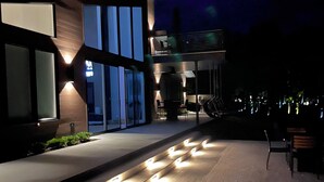 A modern building with large windows and a well-lit entrance area.