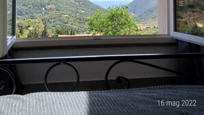 Una stanza con una grande finestra che offre vista su un paesaggio montuoso.