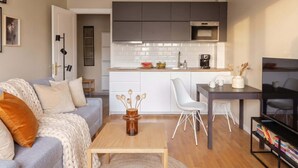 A modern apartment with a living room, kitchenette, and dining area. - TurnKey | Angelo Roma Cozy Studio  III (Praha 2)