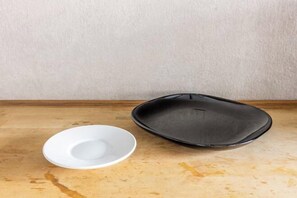 A white bowl and a black tray on a wooden surface. - Rent Tsuruhashi (Osaka)