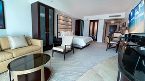 A modern hotel room with a large bed, a sofa, a chair, a TV, and a desk. - FontaineBleau Balcony 10 min from SoBe (Miami Beach)