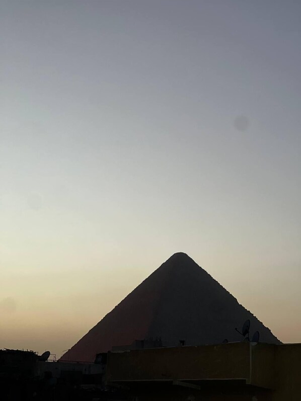 A mountain silhouette against a clear sky.