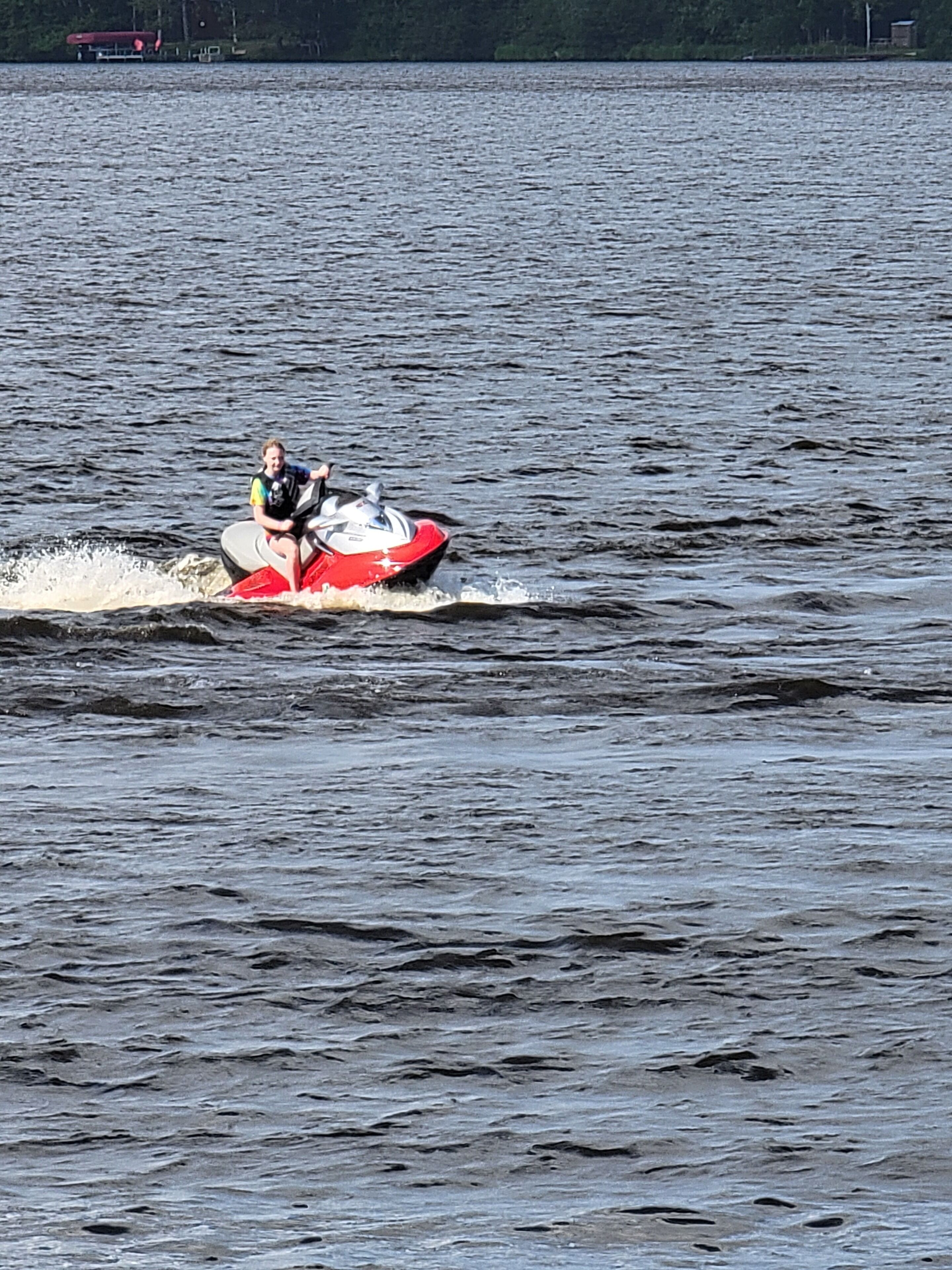 A person riding a jet ski on a large body of water.