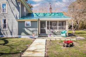 Cozy home with a screened porch and a well-manicured lawn.