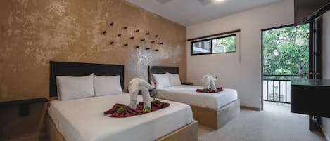 A hotel room with two beds, a ceiling fan, a large window, and a balcony with a view of greenery.