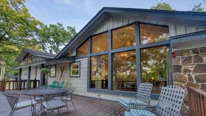 A wooden deck with outdoor furniture, large windows, and a stone wall. - Tenkiller Lake Private Pickleball Court
Sleeps 20
Shuffleboard Pool Table
13Beds (Cookson)