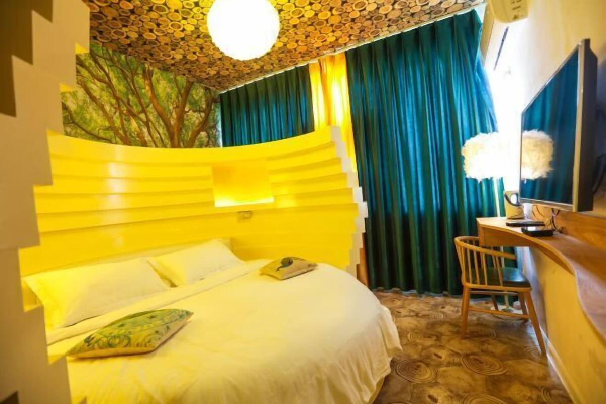 A room with a bed, a desk, and a chair.