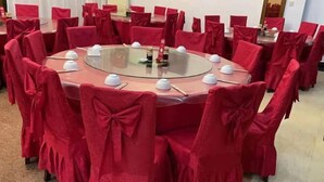 A conference room with a round glass table surrounded by red-covered chairs. - Junting Hotel, Taohua Island (Zhoushan)