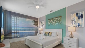 A bedroom with a large window, a bed, a nightstand, and a ceiling fan. - Lake View Cozy Home w/ Pool & Games Near Disney (Kissimmee)