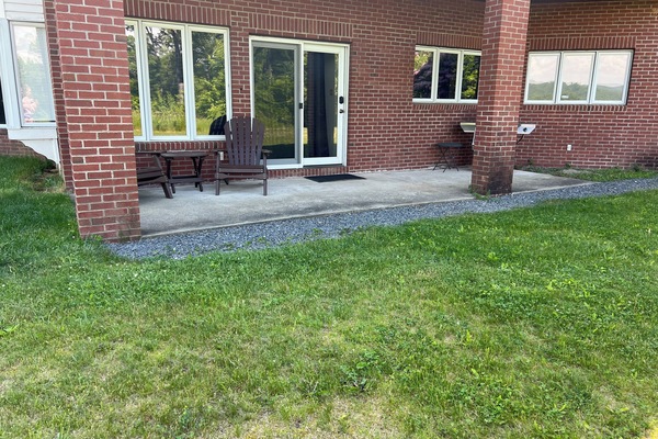 Guest suite entrance and patio area with outdoor grill.