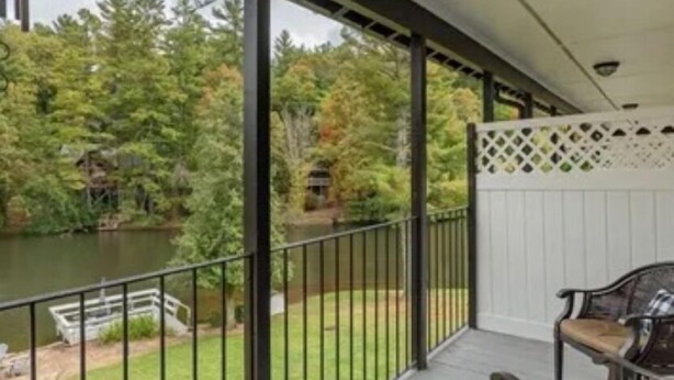 A covered outdoor area with a view of a lake and trees. - Gorgeous serene lake and beach front hide away (Flat Rock)