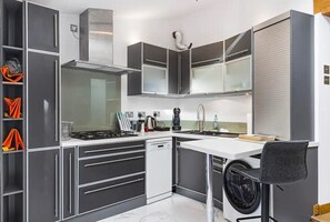 Efficient kitchen with appliances, ample counter space, and storage.