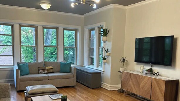 A modern living room with a sofa, coffee table, and TV.